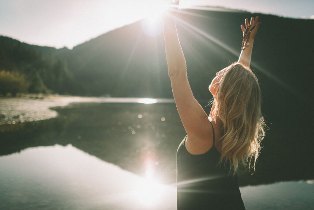 a young woman opening her arms towards the sun 2023 11 27 04 54 31 utc 1